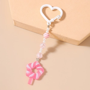 Detail of pink and white beaded keychain featuring a star-shaped candy pendant and heart clasp