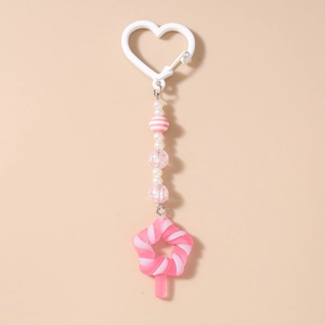 Detail of pink star lollipop charm with white heart clasp and colorful beaded fringe