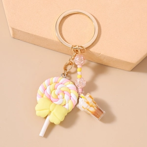 Detail of beaded keychain featuring a spiral lollipop, sundae cup charm, and golden chain