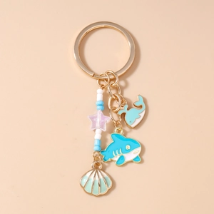 Detailed view of ocean-themed keychain with shark, whale, shell charms and colorful beads