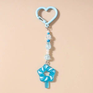 Detailed shot of blue star lollipop keychain with beaded charms and heart hook