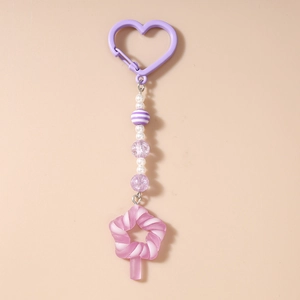 Detailed view of beaded keychain with pink lollipop pendant and purple heart-shaped clip