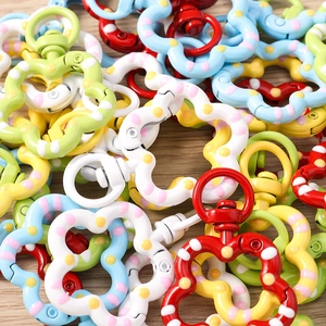 Detailed macro view of colorful spotted floral lobster clasps for DIY keychains