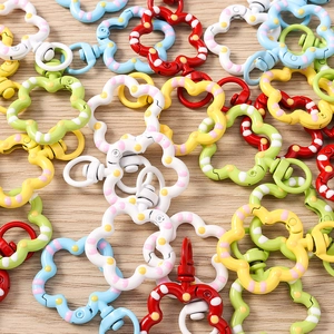 Detailed macro view of colorful floral lobster clasps with decorative polka dot petals