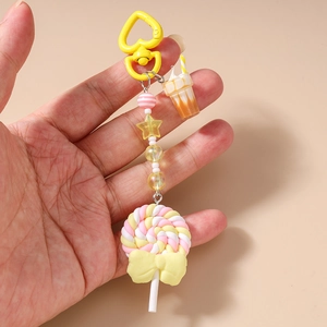 Detail of sweet ice cream and lollipop keychain with pink and white striped beads