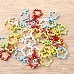Detailed view of five colorful flower-shaped metal lobster clasps for DIY keychains