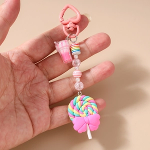 Detail of sweet lollypop keychain with pink heart clasp and striped polymer beads