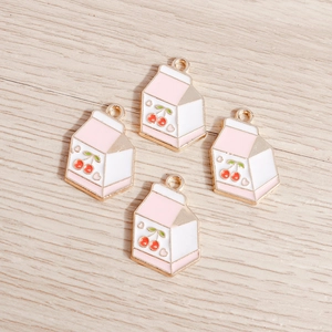 Detailed macro view of four cherry milk carton alloy pendants with pink enamel finish