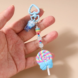 Detail of colorful dessert keychain with clay beads and striped lollipop pendant charm