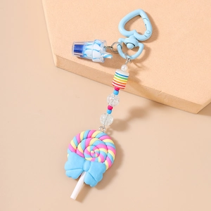 Close-up of colorful polymer clay lollipop keychain with blue bow and rainbow beads