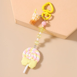 Detail of candy keychain featuring swirl lollipop and miniature coffee cup charms