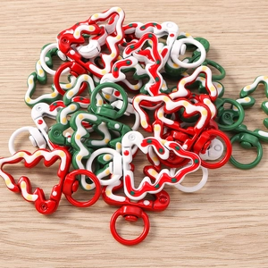 Close-up of colorful Christmas tree lobster clasps in red, green, and white for keyrings