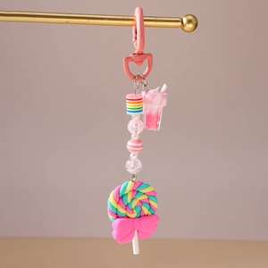 Close-up of dessert-themed keychain with colorful lollipop and macaron beads