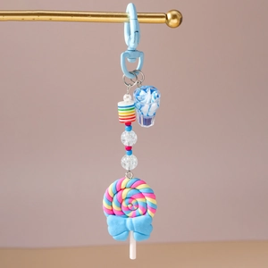 Detailed macro view of colorful lollipop keychain with a blue bow and striped beads