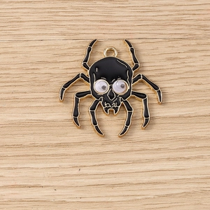 Detail of a gold-plated spider pendant with googly eyes for Halloween jewelry making