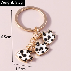 Detail view of goldfish keychain with three black and white enamel fish charms and dimensions