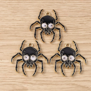 Three spooky black enamel spider skull pendants for Halloween jewelry making and DIY crafts