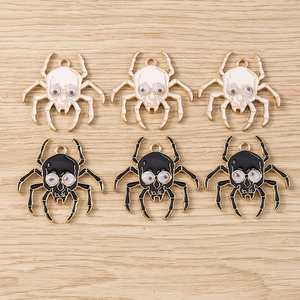 Detailed macro view of skull spider charms with moving eyes for DIY jewelry making