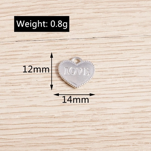 Macro shot of silver LOVE heart pendant with size details 14mm by 12mm and 0.8g weight