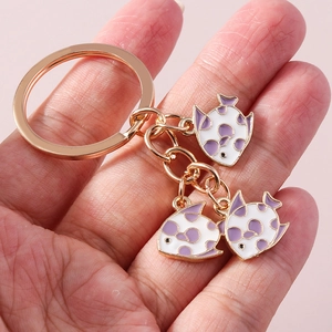 Fashionable gold goldfish keychain with purple polka dot enamel fish charms on a ring