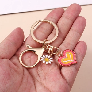 Pink and yellow heart enamel keychain with white daisy flower charm and gold lobster clasp