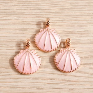 Detail of pink enamel shell charms with rose gold metal edges for DIY jewelry making
