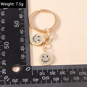 Fashion gold keychain with pearl rhinestone smiley charms and weight 7.5g label