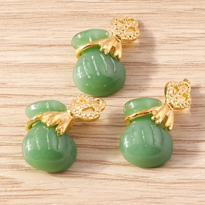 Three pieces of Chinese style fortune bag pendants with green jade-like texture and gold metal
