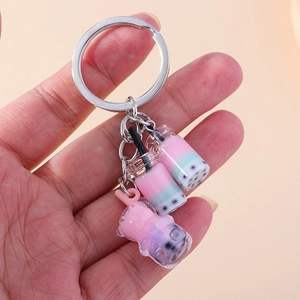 Creative bubble tea keychain featuring colorful milk tea cups and a cute pink bear charm