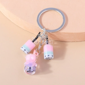 Detailed view of bubble tea charms and a cute bear pendant on a metal keychain