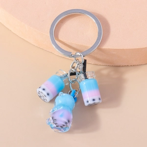 Macro shot of bubble tea cup and blue bear charms on a silver metal keychain