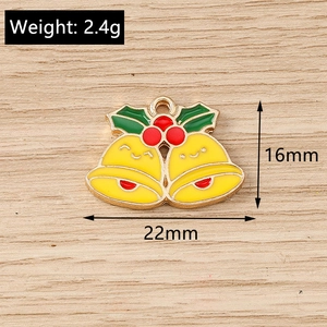 Macro view of a 16x22mm smiling Christmas bell charm with holly berries on wood background