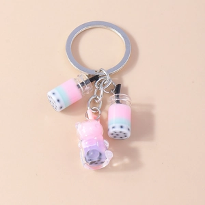 Detail view of cute bubble tea keychains featuring mini tea cups and a cat-shaped pendant