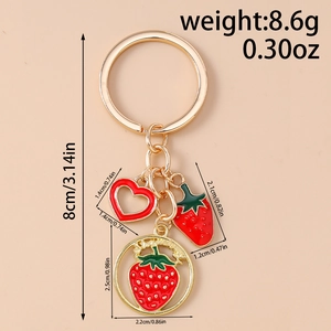 Detailed view of red strawberry keychain with gold plating and dimension markings