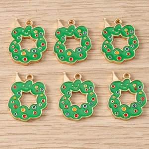 Detail view of green Christmas wreath charms with colorful dots and gold metal loops