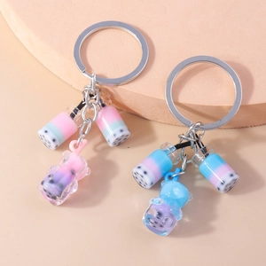 Detailed close-up of bubble tea keychain charms with mini cups and liquid bear pendant