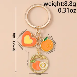 Size chart for fruit keychain with dimensions for heart and orange enamel pendants