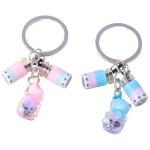 Set of two bubble tea and bear keychains with liquid and pearls in pastel gradients