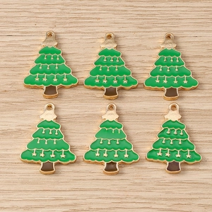Macro view of green enamel Christmas tree pendants with gold plating for DIY jewelry