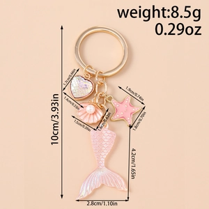 Detailed view of pink mermaid tail keychain with starfish and shell showing dimensions