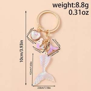 Detailed view of mermaid tail keychain with iridescent scales and golden heart charms