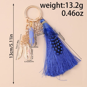Blue tassel keychain featuring a dreamcatcher, metal feathers, and a violet crystal pillar