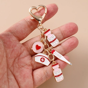 Nurse medical keychain with gold heart ring, pill bottles, hat and thermometer pendants
