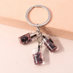Detailansicht von drei Miniatur-Boba-Tee-Anhängern an einem silbernen Schlüsselbundglied