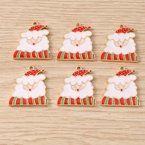 Detail view of colorful Santa Claus enamel charms with gold trim for DIY Christmas jewelry