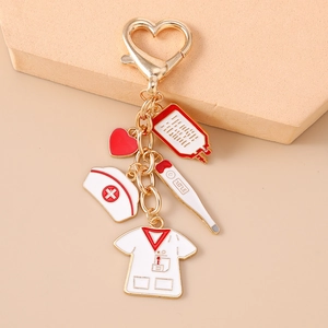 Nurse themed enamel keychain with heart, thermometer and medical uniform charms