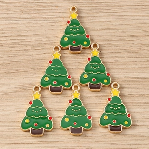 Detail of six smiling green enamel Christmas tree charms for DIY jewelry making and crafts