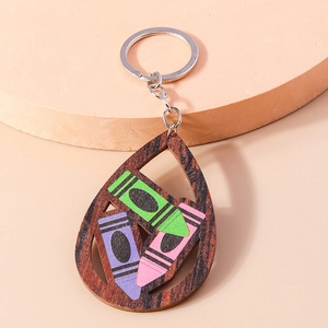 Detail view of wooden teardrop keychain with colorful crayon pattern and metal ring