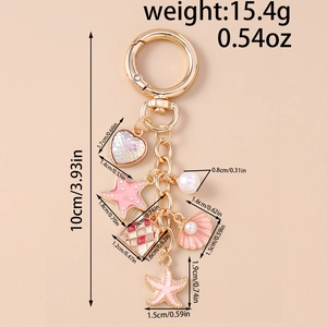 Detail view of gold ocean keychain showing 10cm total length and 15.4g weight specifications