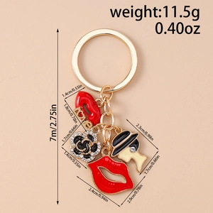 Detail of creative gold keychain with red lips, love charm, and diamond-studded rose
